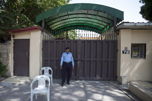 A Pakistani police officer stands guard outside a sealed 'Save the Children' office in Islamabad, Pakistan (Photo: AP) A Pakistani police officer stands guard outside a sealed 'Save the Children' office in Islamabad, Pakistan (Photo: AP)